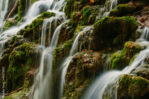 Detailed view of a beautiful crystal watered waterfall in the forest