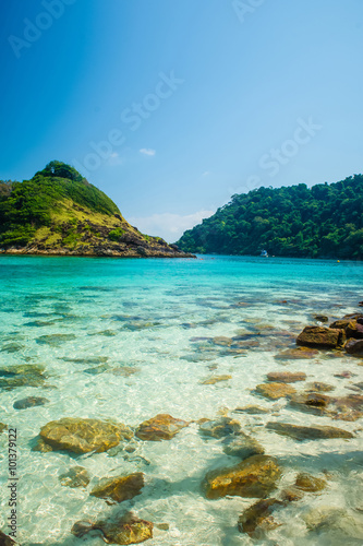 Beautiful clear green turquoise water and rocks with blue sky an