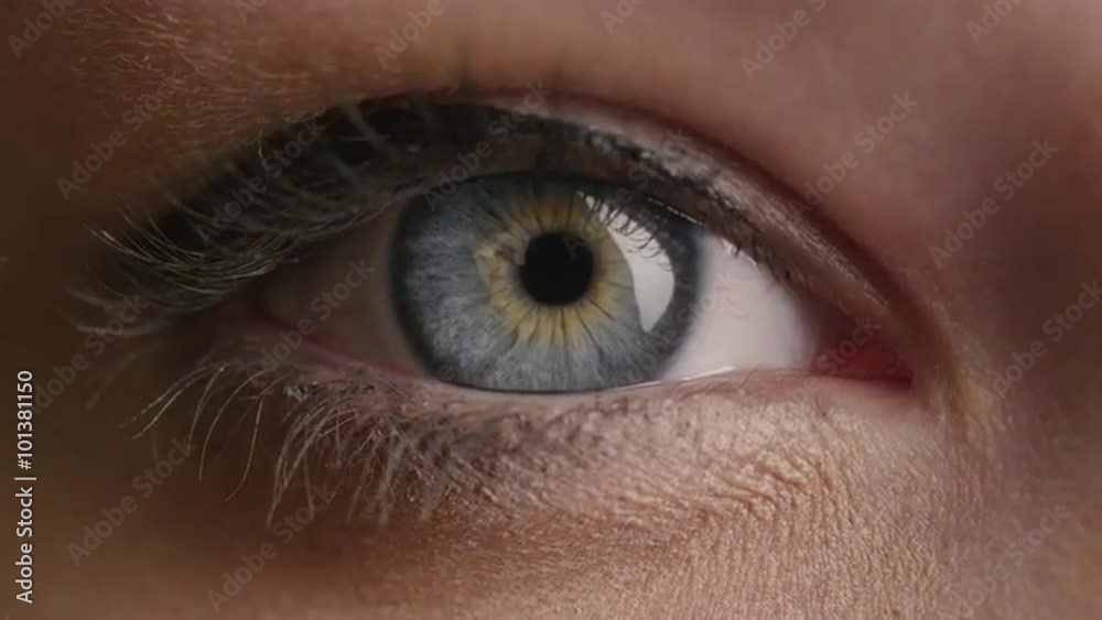 Close-up shot of a woman opening her blue eyes with light day make-up and focusing them. Shot on RED Cinema Camera.