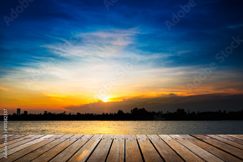 Wooden walkway on sunset background