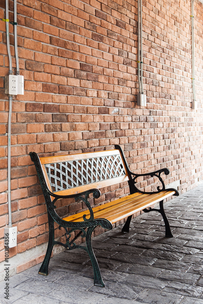 Bench against brick wall