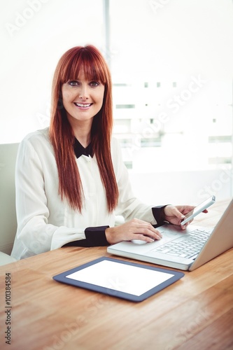 Mid section of a hipster businesswoman using her devices