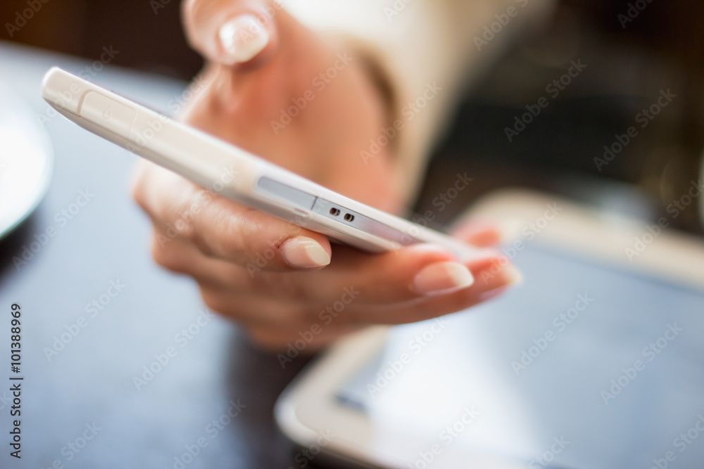 woman holds a smartphone telephone, works on the digital tablet, soft focus, close up woman holds a smartphone telephone, works on the digital tablet, soft focus, close up