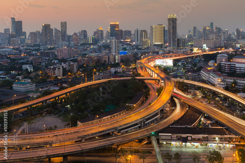 Aerial view city downtown background with highway intersection during twilight