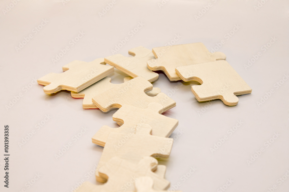 Wooden puzzle is laid out in a row - obrazy, fototapety, plakaty 
