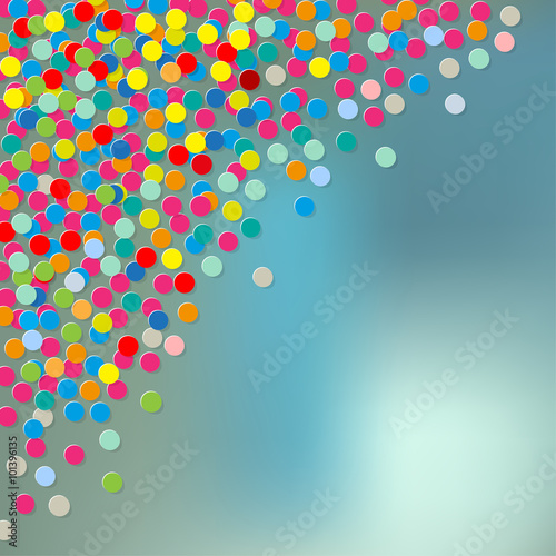 Paper colorful Confetti in the Corner on a blue bokeh fog background.