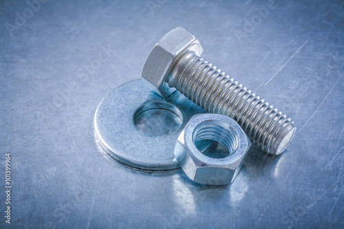 Metal bolt washer screwbolt screw-nut on scratched metallic back