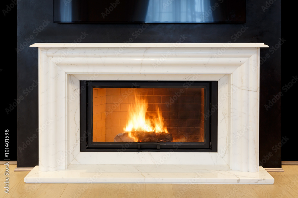 white, marble fireplace and burning fire. white, marble fireplace and burning fire.
