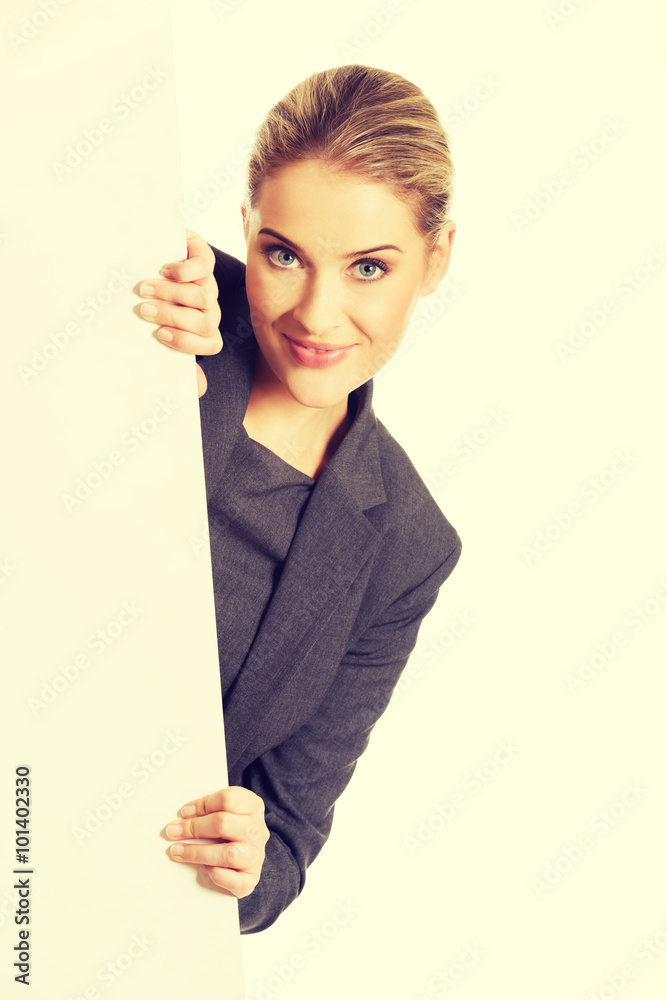 Businesswoman holding empty billboard Businesswoman holding empty billboard