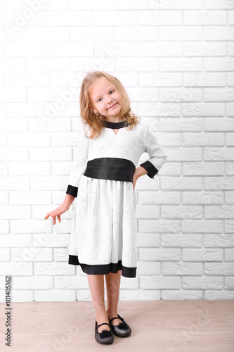 Little girl in dress on a w...