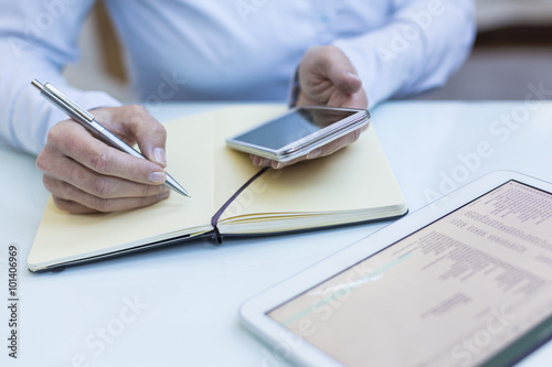 Talking notes on a notebook, tablet computer, smartphone, close-up