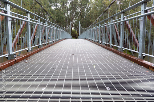 Fototapet Steel Suspension footbridge over river