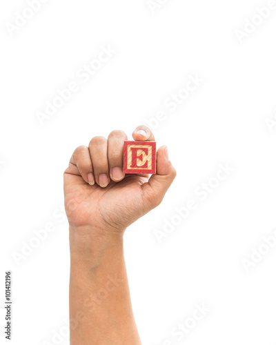 Hand holding colorful alphabet blocks "C" isolated on white back