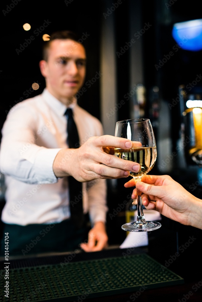 Fotografie Barman giving a drink to customer