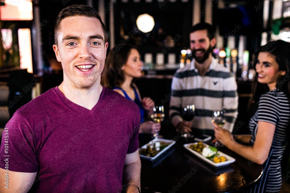 Portrait of man having a drink with friends Portrait of man having a drink with friends