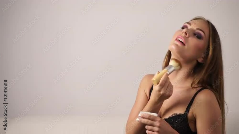 Woman in lingerie applying loose powder with brush 4K Woman in lingerie applying loose powder with brush 4K