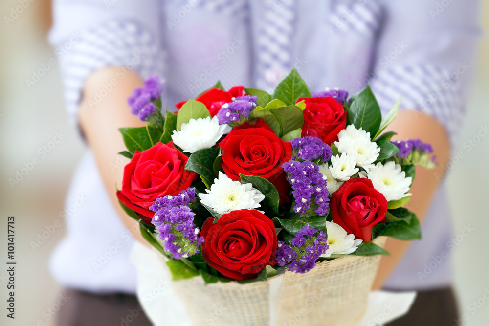 Woman holding a bouquet of roses in hand for Valentine's Day , b Woman holding a bouquet of roses in hand for Valentine's Day , b