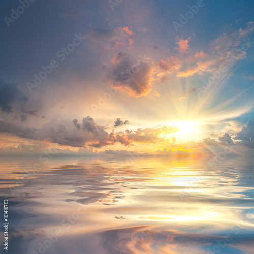 Sunset over sea with reflection in water © firewings