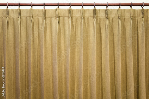 Brown curtains hang on the curtain rail.