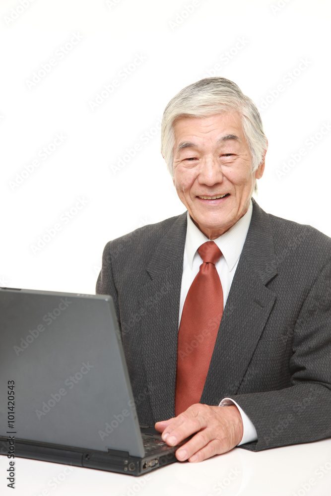 senior Japanese businessman using laptop computer senior Japanese businessman using laptop computer
