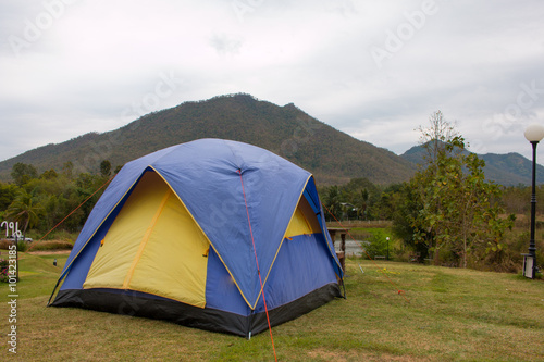 Tourist tent in camp among meadow in the mountain