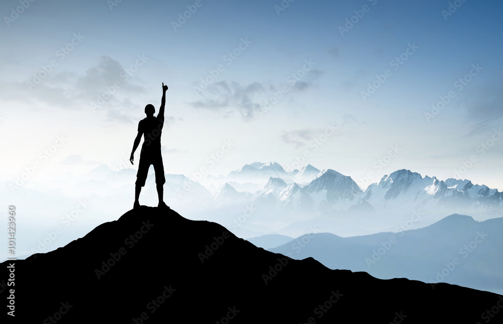 Winner silhouette on the mountain top. Sport and active life concept..