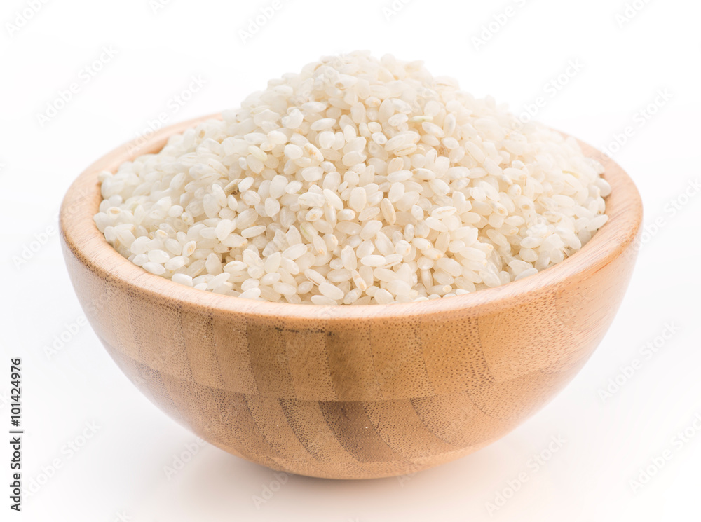 uncooked rice in wooden bowl uncooked rice in wooden bowl