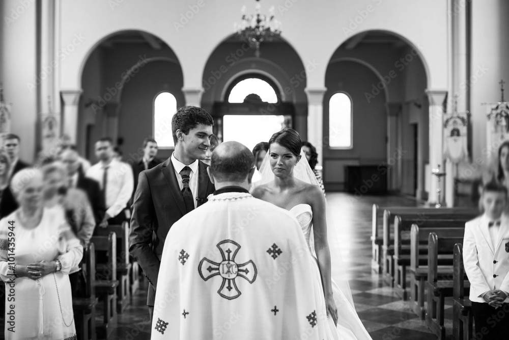 Young elegant happy bride at the ceremony in the church Young elegant happy bride at the ceremony in the church