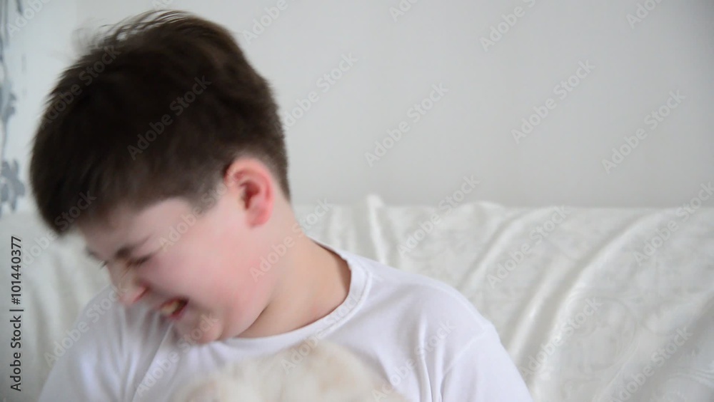 Teenage boy playing with kitten 4 months Teenage boy playing with kitten 4 months