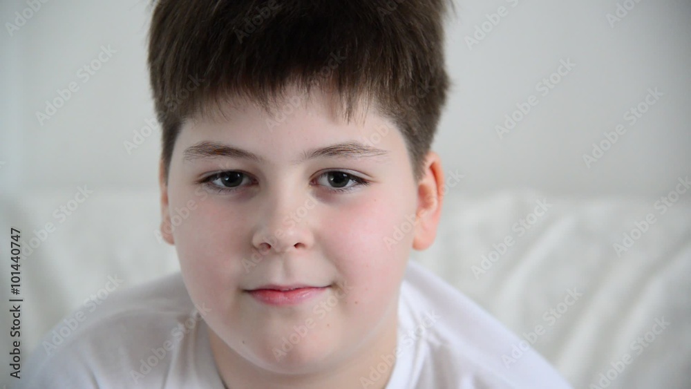 Boy teenager answers questions, grimaces and laughs Boy teenager answers questions, grimaces and laughs