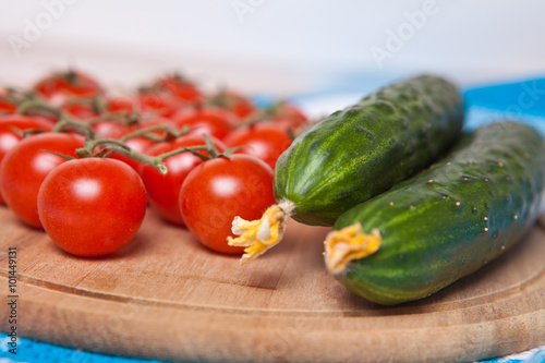 Fototapeta Naklejka Na Ścianę i Meble -  cherry tomatoes and cucumbers on a wooden background