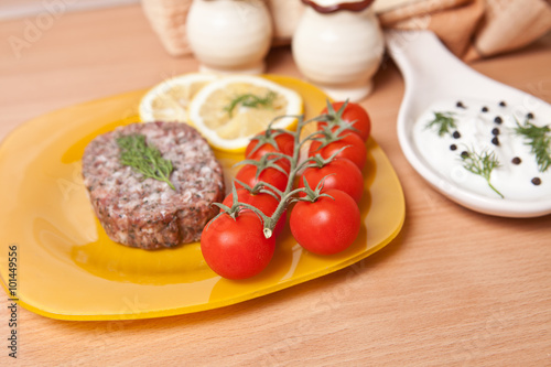 cutlet on a plate with cherry tomatoes