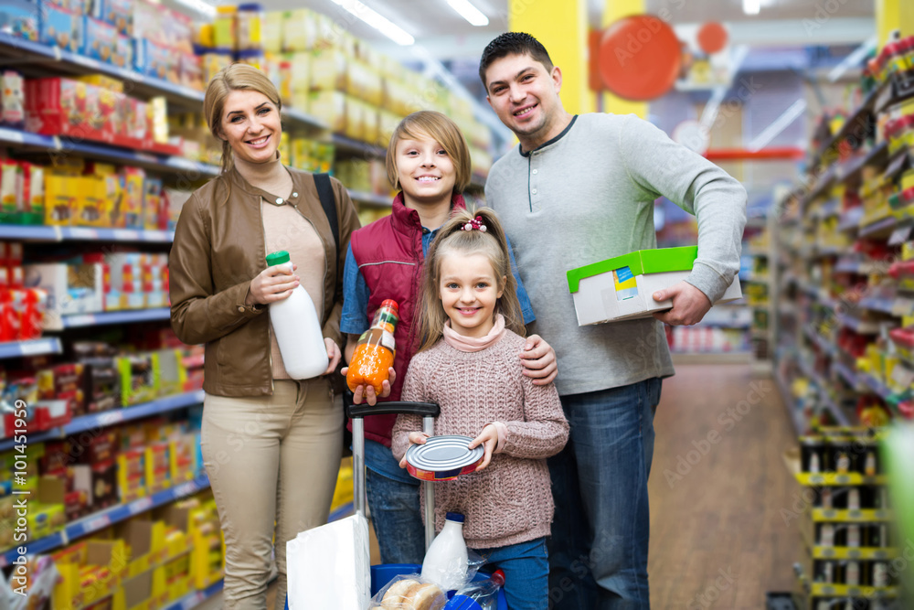 Portrait of  family with two children in local supermarket