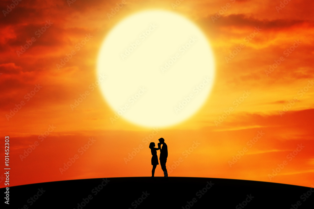 Dramatic couple standing on the hill