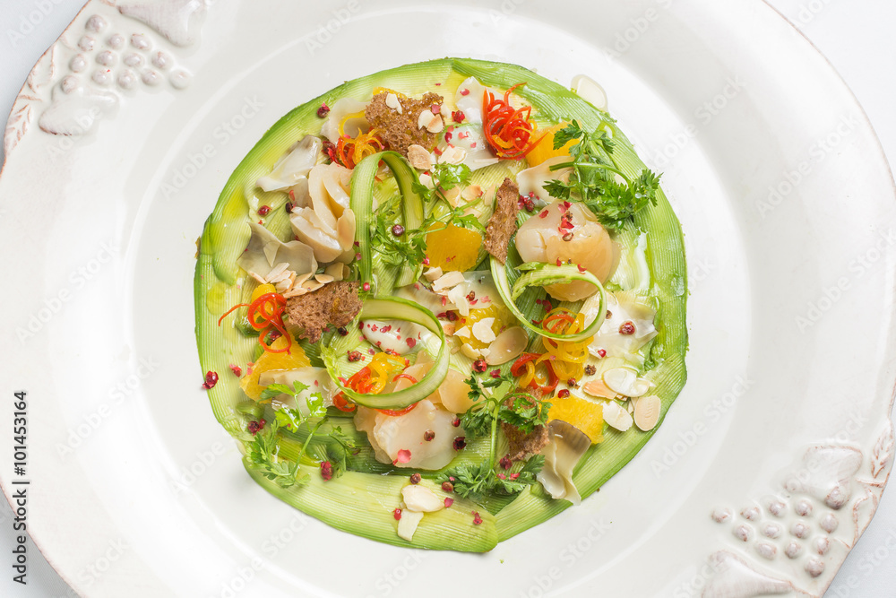 Carpaccio of prawns with citrus sauce on a white background. Gourmet cuisine. Carpaccio of prawns with citrus sauce on a white background. Gourmet cuisine.