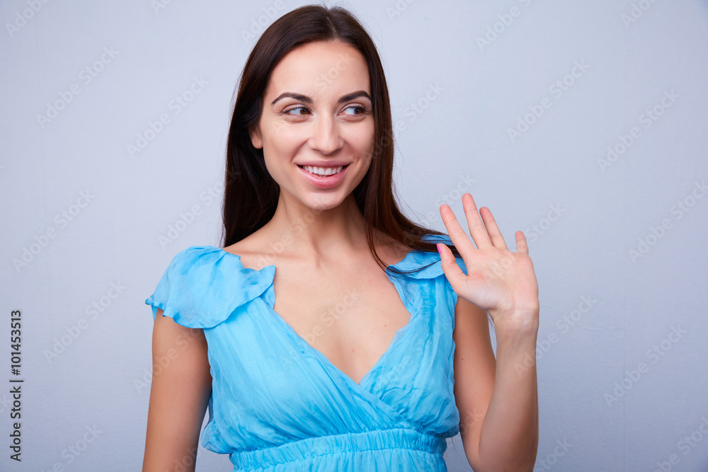 brunette smiling and waving to brunette smiling and waving to