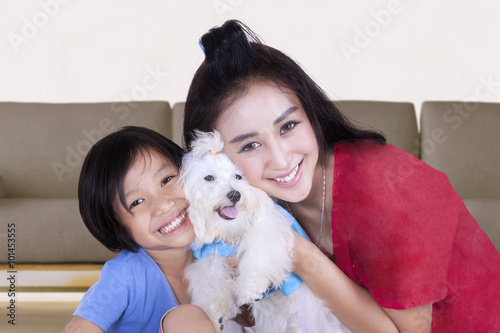 Pretty woman and child holding dog