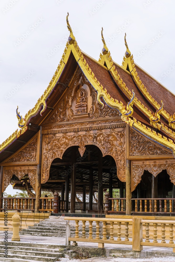 Naklejka premium beautiful of Wooden carve : sermon hall in a monastery - Thailand public temple