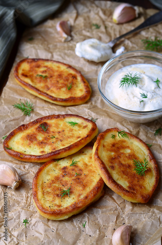 Mashed Potato Fritters with Sour Cream on wooden rustic background