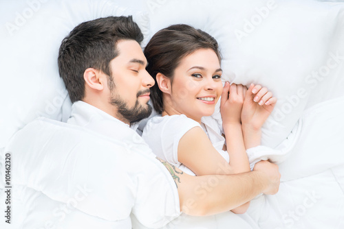 Nice loving couple lying in bed 