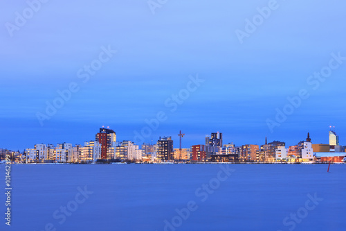 Bild auf Leinwand Vasteras skyline in sunset with lake Malaren in the front.