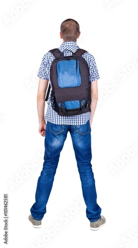Back view of man with backpack looking up.
