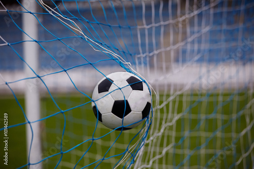 soccer ball in goal net 