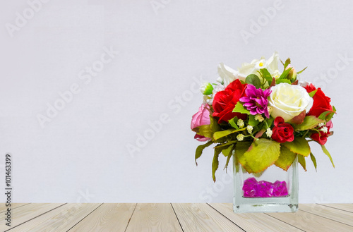 Beautiful Multi Color of Roses in Glass Flowerpot at The Corner on Wooden Table with Gray Background with Copyspace for Mock up to Display Product or input Text on Valentine Event © jackritw