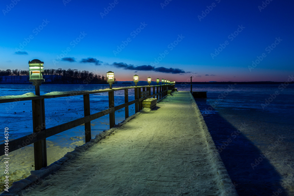 Jetty with lights during sunset a winter night Jetty with lights during sunset a winter night