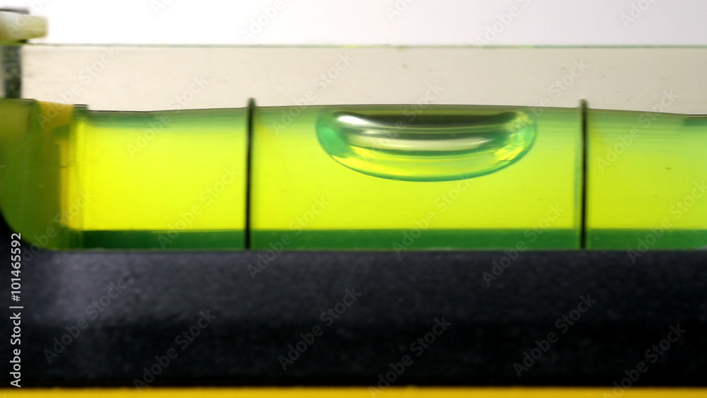 Carpenter's spirit level close up. Measuring the flatness with a spirit level.