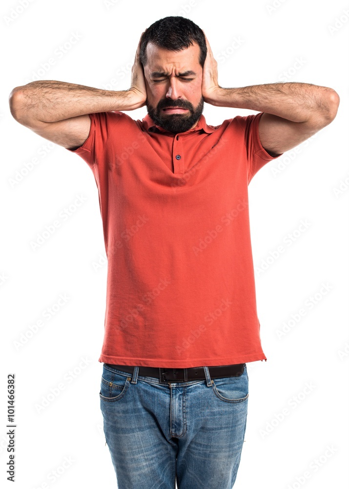 Handsome man covering his ears Handsome man covering his ears