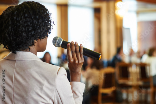 female speaker with microphone
