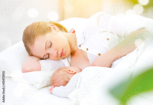 sleeping together and breastfeeding mother and newborn baby in b