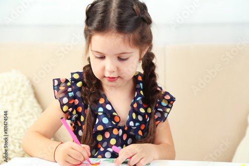 Cute little girl drawing pi...